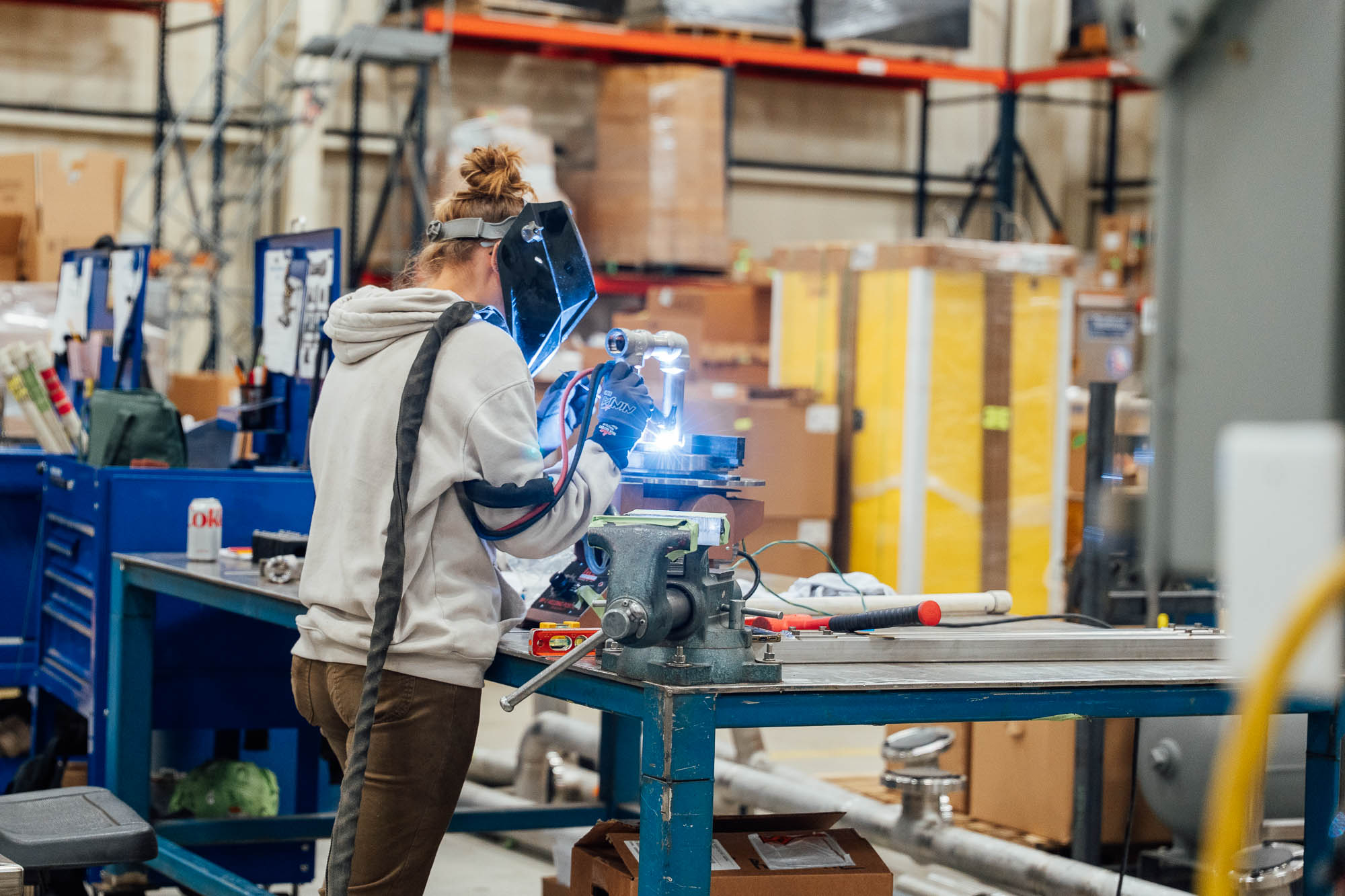 AmeriChem team member welding inside the production facility