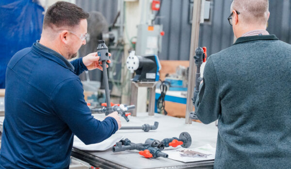 Two men building a custom process system
